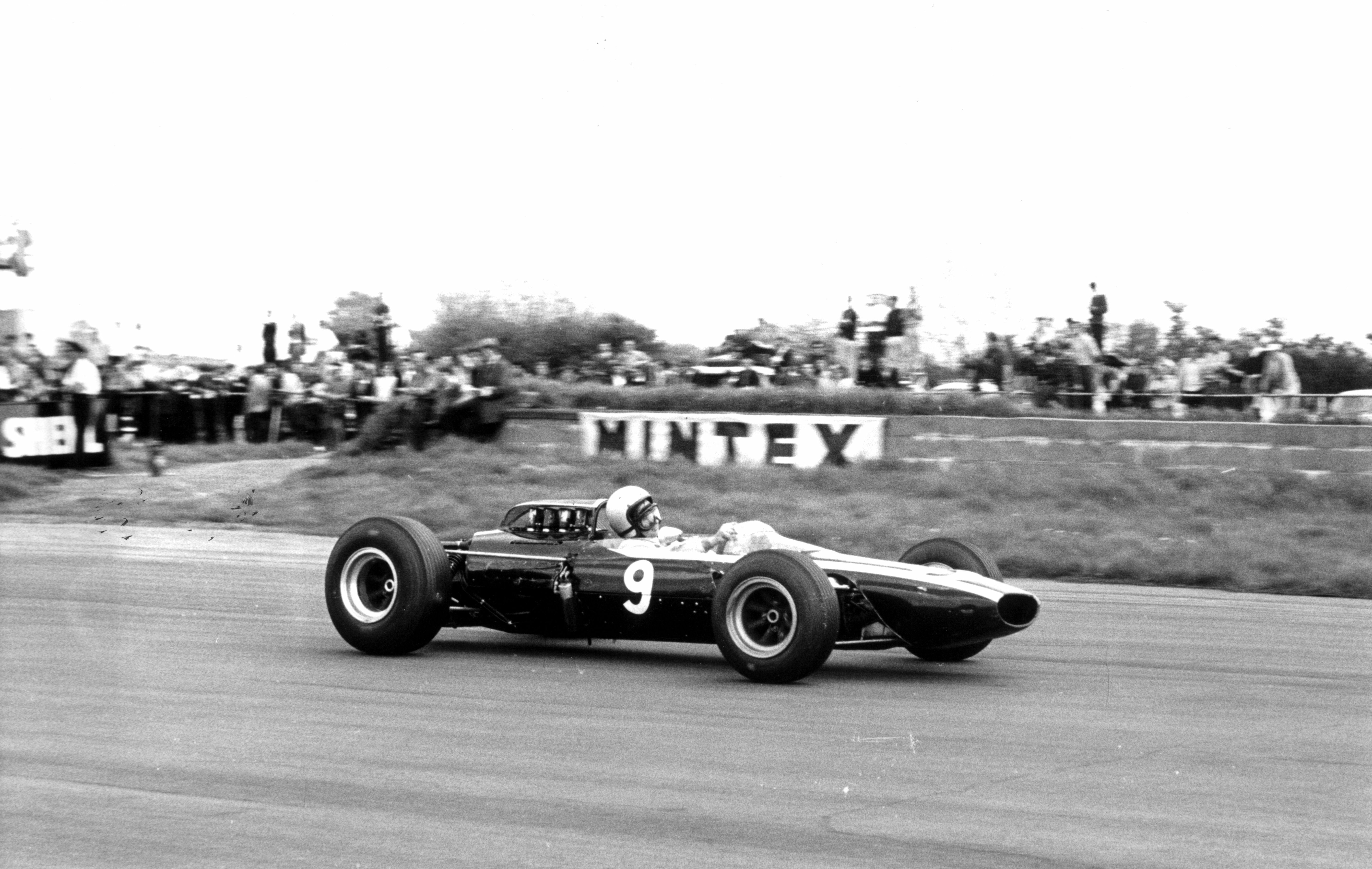 A vintage single-seater racing at speed